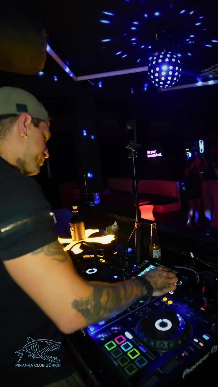 DJ mit Cap unter der Discokugel